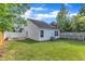 View of back yard, highlighting the fenced perimeter and well-maintained lawn at 5420 Roan Mountain Pl, Raleigh, NC 27613