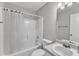 Bathroom with a shower-tub combo, white tile, and a vanity with sink at 5420 Roan Mountain Pl, Raleigh, NC 27613