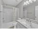 Well-lit bathroom features a shower-tub combo and a marble-topped vanity at 5420 Roan Mountain Pl, Raleigh, NC 27613