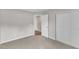 Bedroom with large sliding-door closet and open doorway showing hardwood floors at 5420 Roan Mountain Pl, Raleigh, NC 27613