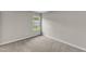 Bedroom with neutral carpet, gray walls and a window overlooking the yard at 5420 Roan Mountain Pl, Raleigh, NC 27613