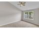 Bedroom with carpet and ceiling fan has large window providing natural light at 5420 Roan Mountain Pl, Raleigh, NC 27613