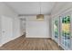 Dining room featuring a modern light fixture and a door leading to the home's backyard at 5420 Roan Mountain Pl, Raleigh, NC 27613