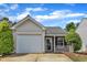 Charming single-Gathering home featuring a one-car garage, brick accents, and a well-maintained front yard at 5420 Roan Mountain Pl, Raleigh, NC 27613