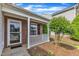 Brick front porch with white railings and a storm door leading to the entrance of the home at 5420 Roan Mountain Pl, Raleigh, NC 27613