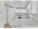 All-white kitchen featuring updated appliances, modern cabinets, and lots of counter space at 5420 Roan Mountain Pl, Raleigh, NC 27613