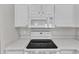 Close up of kitchen appliances including smooth cooktop and microwave at 5420 Roan Mountain Pl, Raleigh, NC 27613