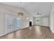 Open living space with a fireplace, ceiling fan, and access to the backyard via French doors at 5420 Roan Mountain Pl, Raleigh, NC 27613