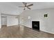 Living area with fireplace, doors to the backyard, light walls, ceiling fan, and LVP floors at 5420 Roan Mountain Pl, Raleigh, NC 27613