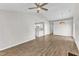 Spacious living area with a ceiling fan, light-colored walls, and an opening leading to the kitchen at 5420 Roan Mountain Pl, Raleigh, NC 27613