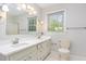 Bathroom features dual vanity sinks, tile flooring, updated fixtures, and a modern design at 5513 Parkwood Dr, Raleigh, NC 27612