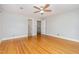 Large bedroom with hardwood floors, neutral paint, and ceiling fan at 5513 Parkwood Dr, Raleigh, NC 27612