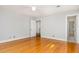Bedroom featuring hardwood flooring, great light, and convenient access to other rooms at 5513 Parkwood Dr, Raleigh, NC 27612