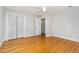 Spacious bedroom featuring hardwood floors, a ceiling fan, and bi-fold closet at 5513 Parkwood Dr, Raleigh, NC 27612