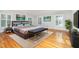 Spacious main bedroom with many windows, hardwood floors, and soft area rug at 5513 Parkwood Dr, Raleigh, NC 27612