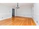 Empty dining room featuring hardwood floors, classic molding, and ample natural light at 5513 Parkwood Dr, Raleigh, NC 27612