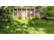 Classic brick home featuring stately white columns and a well-manicured front lawn at 5513 Parkwood Dr, Raleigh, NC 27612