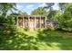 Two-story brick home with white columns, black shutters, and a well-manicured lawn at 5513 Parkwood Dr, Raleigh, NC 27612