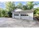 Detached two car garage with carriage doors and parking pad at 5513 Parkwood Dr, Raleigh, NC 27612