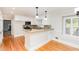 Bright kitchen with white cabinets, granite countertops, and stainless steel appliances at 5513 Parkwood Dr, Raleigh, NC 27612