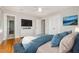 Stylish main bedroom with a large bed, flat screen tv, and walk in closet at 5513 Parkwood Dr, Raleigh, NC 27612