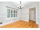Versatile room with hardwood floors, large windows, and neutral tones at 5513 Parkwood Dr, Raleigh, NC 27612