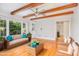 Inviting sunroom features exposed beams, lots of natural light, and comfortable wicker seating at 5513 Parkwood Dr, Raleigh, NC 27612