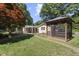 Large backyard featuring a gazebo, screened-in porch, patio, and lush green lawn at 5517 Spring Rd, Raleigh, NC 27603