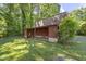 The red barn sits in the backyard featuring a lean-to overhang with open space at 5517 Spring Rd, Raleigh, NC 27603