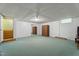 A finished basement with a sliding mirror door closet and large storage cabinet at 5517 Spring Rd, Raleigh, NC 27603