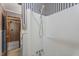 Bathroom featuring striped wallpaper, a shower stall and toilet room at 5517 Spring Rd, Raleigh, NC 27603