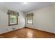 Bright bedroom with hardwood floors and windows offering natural light and views of the surrounding landscape at 5517 Spring Rd, Raleigh, NC 27603