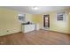 Bright bedroom featuring vinyl floors, windows for natural light and access to an attached bathroom at 5517 Spring Rd, Raleigh, NC 27603