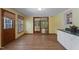 Bright dining room with wood-look flooring and sliding glass doors to an adjacent room at 5517 Spring Rd, Raleigh, NC 27603