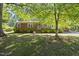 Lovely brick home with charming blue shutters, surrounded by lush greenery at 5517 Spring Rd, Raleigh, NC 27603
