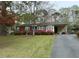 Charming single-story home with brick facade, covered parking, and mature landscaping at 5517 Spring Rd, Raleigh, NC 27603