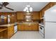 Cozy kitchen featuring knotty pine cabinets, tile floors, and modern appliances at 5517 Spring Rd, Raleigh, NC 27603