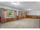 Spacious, airy living room featuring large windows with floral curtains and comfortable seating at 5517 Spring Rd, Raleigh, NC 27603