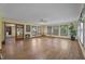 Large living room featuring hardwood floors, multiple windows, and an open layout at 5517 Spring Rd, Raleigh, NC 27603