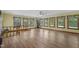 Bright living area with wood floors, large windows, and a staircase leading to a second floor at 5517 Spring Rd, Raleigh, NC 27603