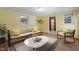 Comfortable living room with a sofa, chair, and a view into the bathroom at 5517 Spring Rd, Raleigh, NC 27603