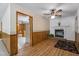 Living room with a fireplace, views to kitchen, and wood floors at 5517 Spring Rd, Raleigh, NC 27603