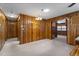 Open living space with wood-paneled walls and views through doorways into other rooms at 5517 Spring Rd, Raleigh, NC 27603