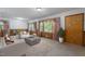 Bright living room featuring large windows with floral curtains and comfortable seating at 5517 Spring Rd, Raleigh, NC 27603