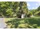 Outdoor shed in a grassy backyard with scattered shade in a fenced-in area at 5517 Spring Rd, Raleigh, NC 27603
