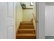 Interior shot of a wooden staircase with white walls and a flower pot in the corner at 5517 Spring Rd, Raleigh, NC 27603