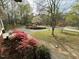 Scenic property with winding driveway, colorful landscaping, and mature trees at 5517 Spring Rd, Raleigh, NC 27603