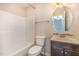 Bright bathroom featuring a shower-tub combo and stylish vanity with an oval mirror at 5622 Osprey Cove Dr, Raleigh, NC 27604