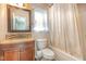 Well-lit bathroom featuring a shower-tub combo with tiled accents and a vanity at 5622 Osprey Cove Dr, Raleigh, NC 27604