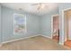 Serene bedroom with a window, ceiling fan, and a view to an ensuite bathroom, creating a private retreat at 5622 Osprey Cove Dr, Raleigh, NC 27604